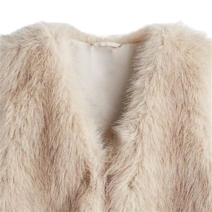 Detailed close-up of beige faux fur vest showing plush texture and inner lining finish