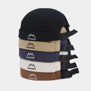 Detail of RAHHSR embroidered brimless docker hats in black, khaki, and navy canvas