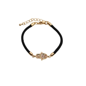 Detail of gold Evil Eye Hamsa hand charm with colored zircons on black cord bracelet