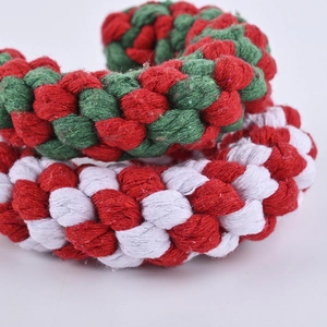 Durable cotton rope dog chew toy in red, green, and white candy cane spiral designs