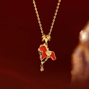 Gold plated zodiac horse necklace with red enamel, coin charm and tassel details