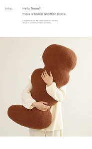 Detailed texture of brown curly teddy fleece fabric on long ergonomic body pillow