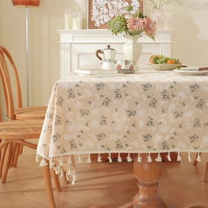 Detail view of cotton linen tablecloth with vintage blue floral prints and tassel fringe