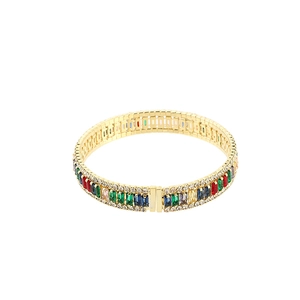 Detailed close-up of gold bracelet with colorful rectangular zircons and crystals