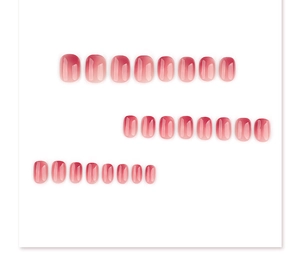 Macro view of pink gradient jelly press on nails in short round shape on white background