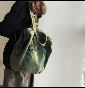 Detail of green canvas backpack showing adjustable strap and durable fabric texture