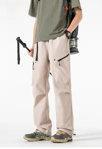 Detail view of khaki tactical pants with multi-pockets and adjustable drawstring hems
