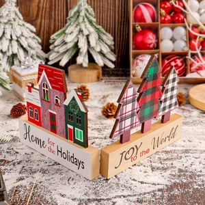 Christmas wooden house and tree ornaments set with festive greetings on a snowy background