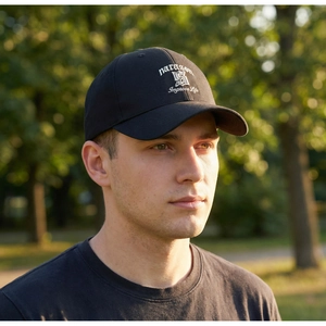 Close-up of white letter embroidery and paragon text on black cotton baseball cap