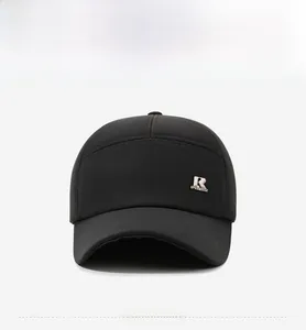 Detail of winter baseball cap featuring silver R Sportbest metal logo on black fabric
