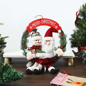 Detail of Santa and Snowman plush dolls on a rustic grapevine wreath with Merry Christmas sign