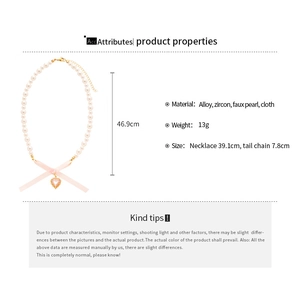 Detail view of heart pendant pearl necklace with ribbon bow and technical dimensions
