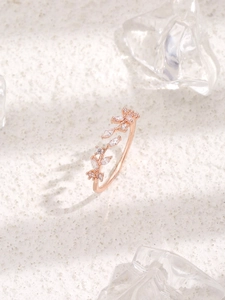 Detailed macro view of rose gold leaf ring with sparkling marquise-cut zircon stones