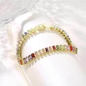 Rainbow cubic zirconia bracelet in gold plating displayed on a white podium stand