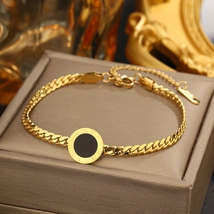 Close-up of gold titanium steel bracelet with Roman numeral pendant on jewelry box