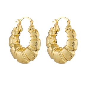 Detail of chunky gold hoop earrings with spiral textured finish and secure leverback closure