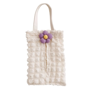 Detail of cream waffle fabric tissue box cover with a purple 3D flower decoration