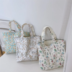 Detailed close-up of printed canvas tote bags featuring floral and animal patterns