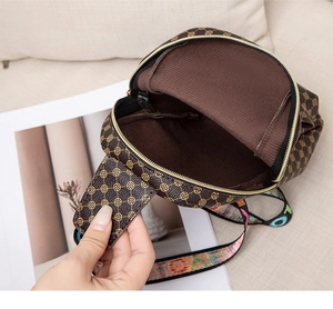 Close-up of vintage polka dot crossbody bag interior and colorful lettered strap