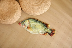 Detailed close-up of a realistic fish plush shell with lifelike patterns on wooden floor