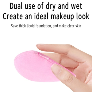Detailed view of a soft pink makeup sponge held by hand for wet and dry cosmetic use