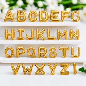 Golden chunky bubble initial pendants from A to Z arranged on a white display stand