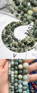 Macro detail of natural green rutilated quartz beads showing silky mineral textures