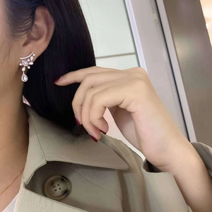Elegant silver pear-shaped drop earrings featuring shimmering leaf-style zircon settings