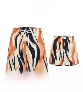 Detail of matching parent-child beach shorts with artistic abstract tiger stripe prints