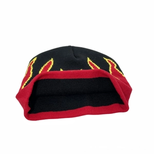 Detailed view of the flame pattern knit beanie with red cuff and black jacquard fabric