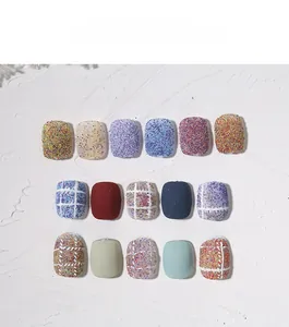 Detailed close-up of colorful tweed texture and glitter nail art powder samples