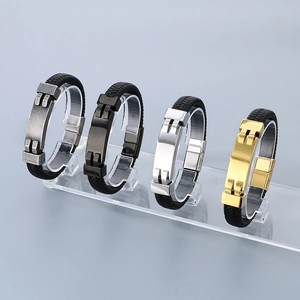 Detail of woven leather bracelets with silver, black, and gold metal accents for men