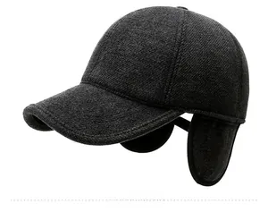 Detail of dark grey wool baseball cap showing sport metal logo and ear protection flap