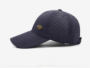 Detail view of navy blue outdoor cap with laser-cut mesh and gold metal badge