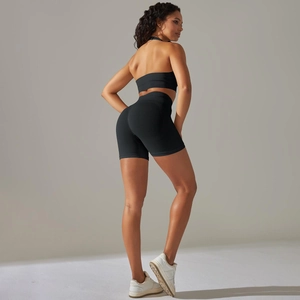 Close-up of black seamless ribbed yoga set featuring a halter bra and high-waist shorts