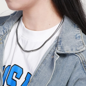 Silver snake bone chain necklace shown on model's neck for a trendy minimalist look