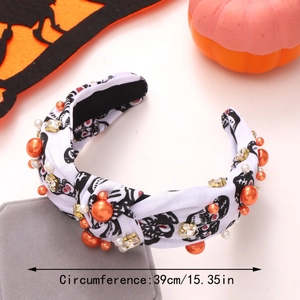 Detail of white Halloween headband with skull print, beads, and size marking