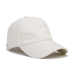 Detailed view of smiley face embroidery on the soft cotton beige baseball cap fabric