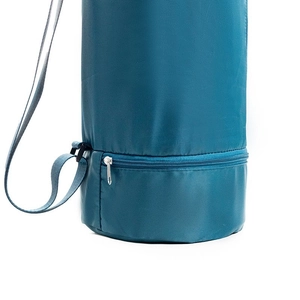 Detail view of teal yoga mat bag featuring a bottom wet compartment and shoulder strap