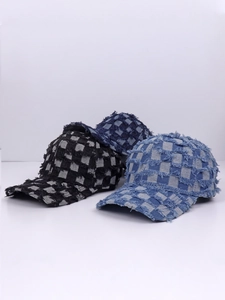 Close-up of three distressed denim checkerboard baseball caps with frayed edge details