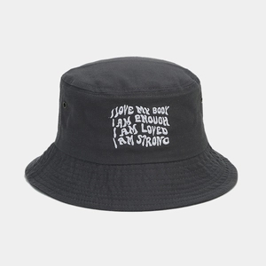 Detail of dark grey cotton bucket hat with white embroidery and metal eyelets