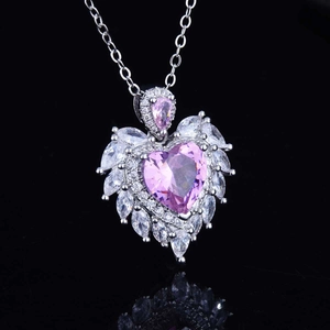 Macro shot of pink heart-shaped crystal pendant with marquise-cut accents and silver chain