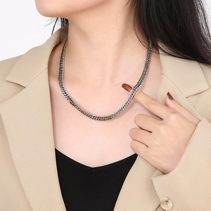 Fashion silver Cuban link chain necklace in stainless steel worn by a female model