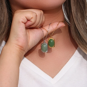 Vintage style gold and silver necklaces with oval green gemstones and hammered metal textures