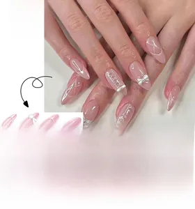 Close-up of pink French press-on nails with white lace patterns, pearls and ribbon bows