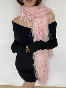 Detail of pink faux fur scarf with soft texture styled on a black off-shoulder dress