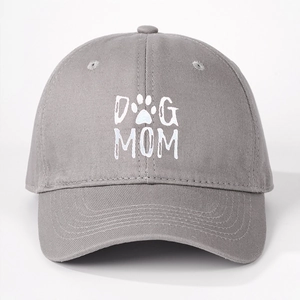 Close-up of the DOG MOM print and paw icon on the light grey cotton baseball cap