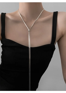 Close-up of minimalist silver snake chain necklace with elegant adjustable knot detail