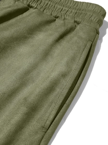 Detail showing olive green joggers with elastic waistband and side pocket texture
