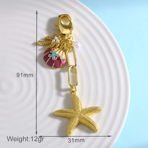 Detailed view of ocean-themed keychain with starfish shell and coconut tree on a white plate